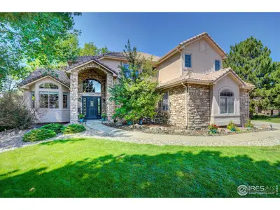 Up a tree-lined street atop a hill is a beautiful stone and stucco home you simp…
